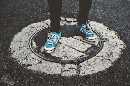 man stood on drain cover