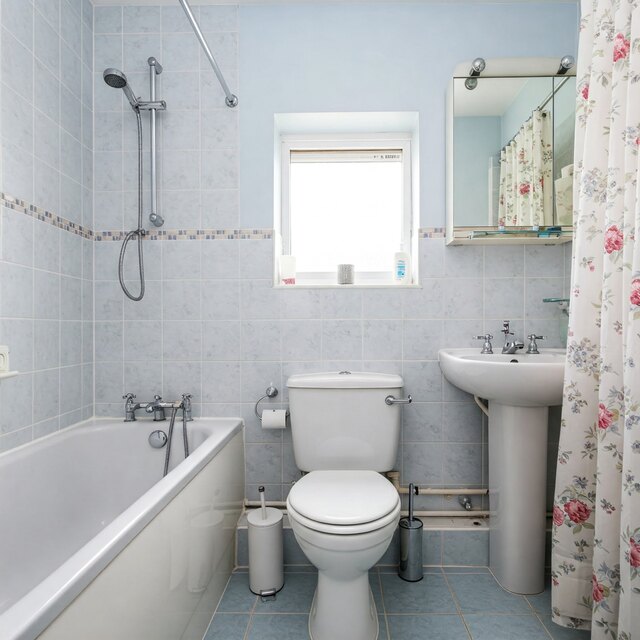 Image of a modern bathroom in Gildersome featuring a toilet with potential blocked drain issues, requiring professional unblocking services.